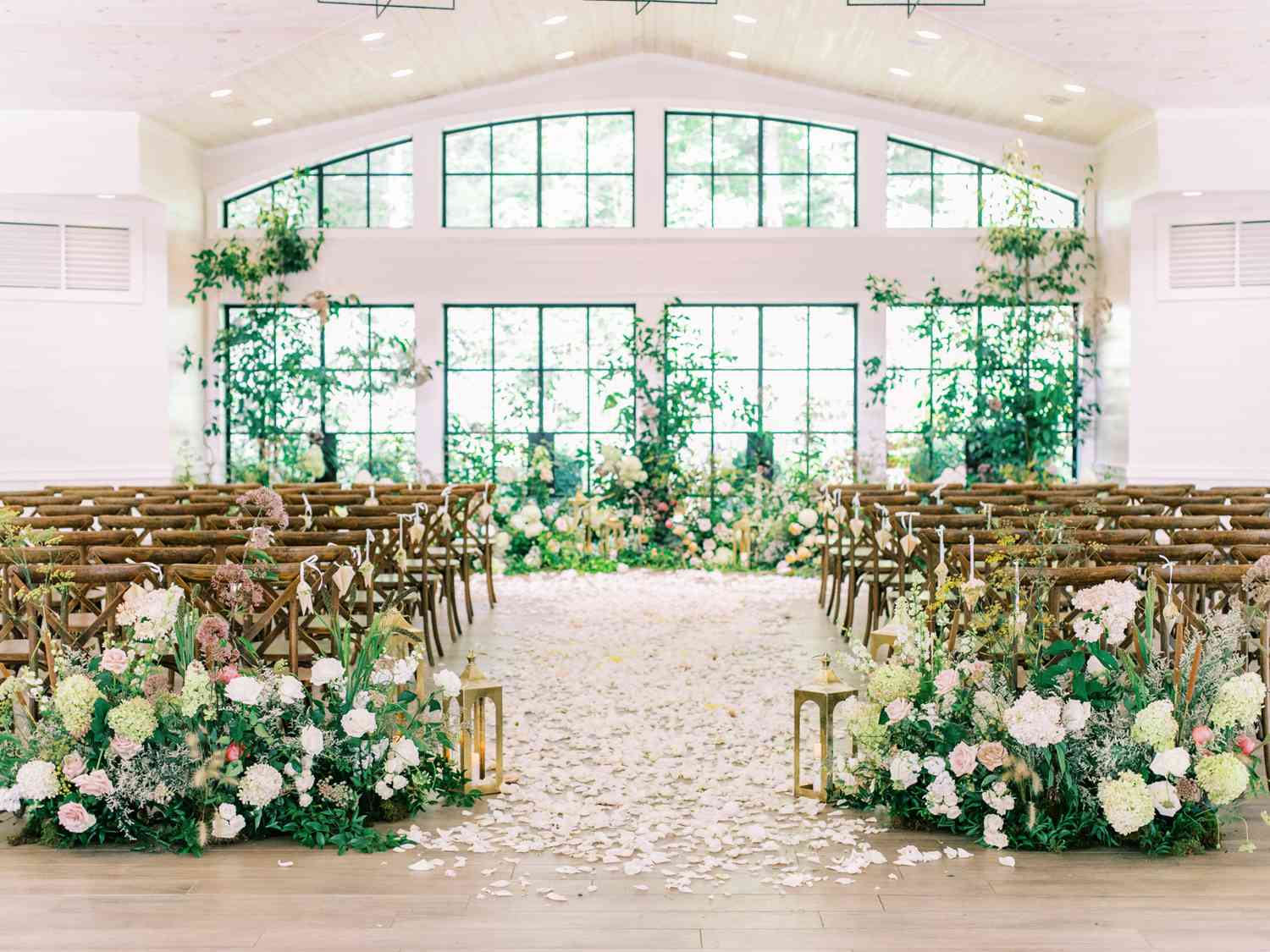 vaulted ceiling wedding ceremony location covered in flowers