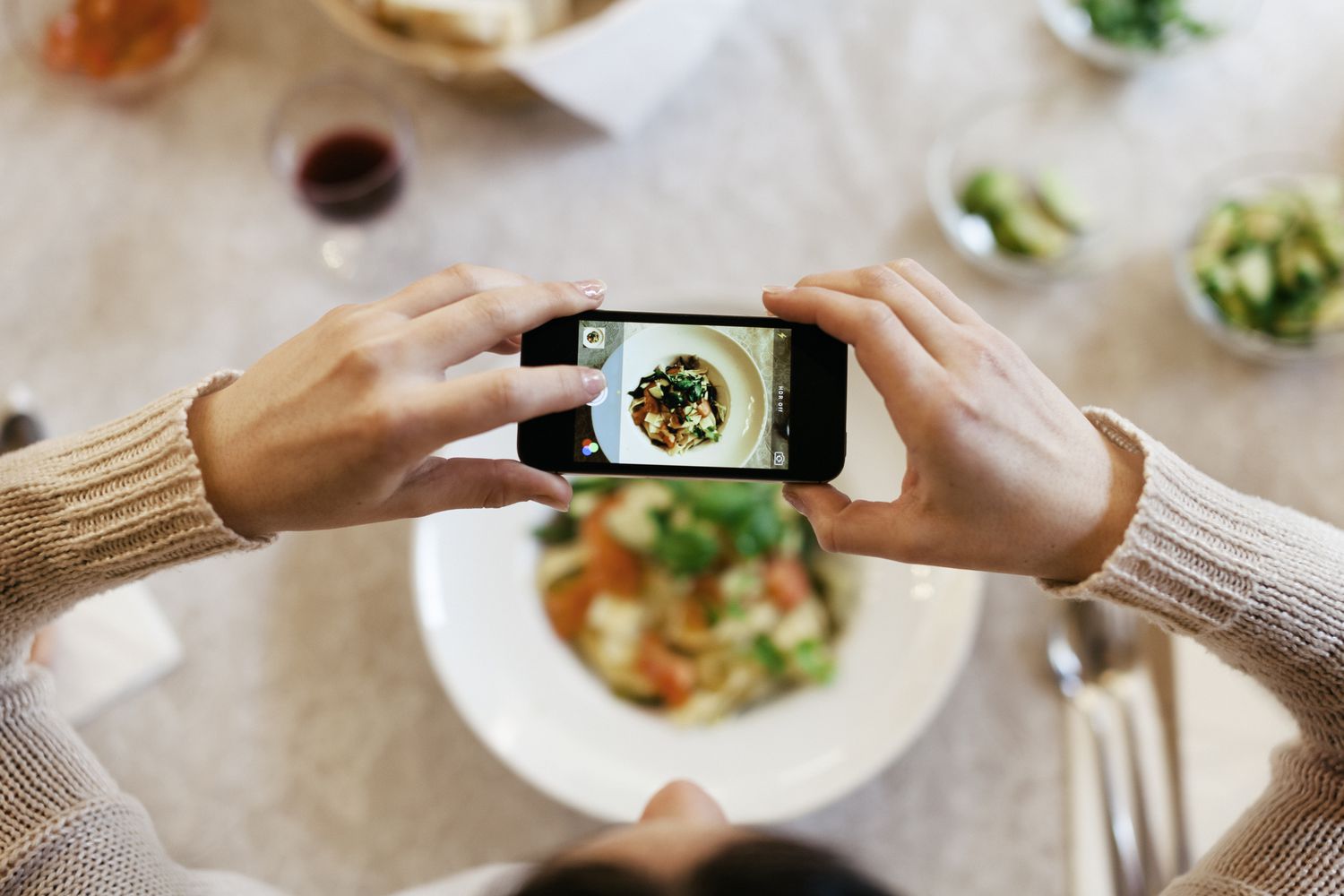 woman taking photo of food