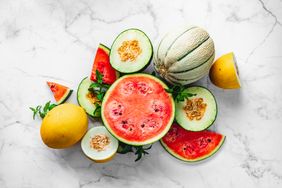 honeydew and watermelon fruits on marble surface