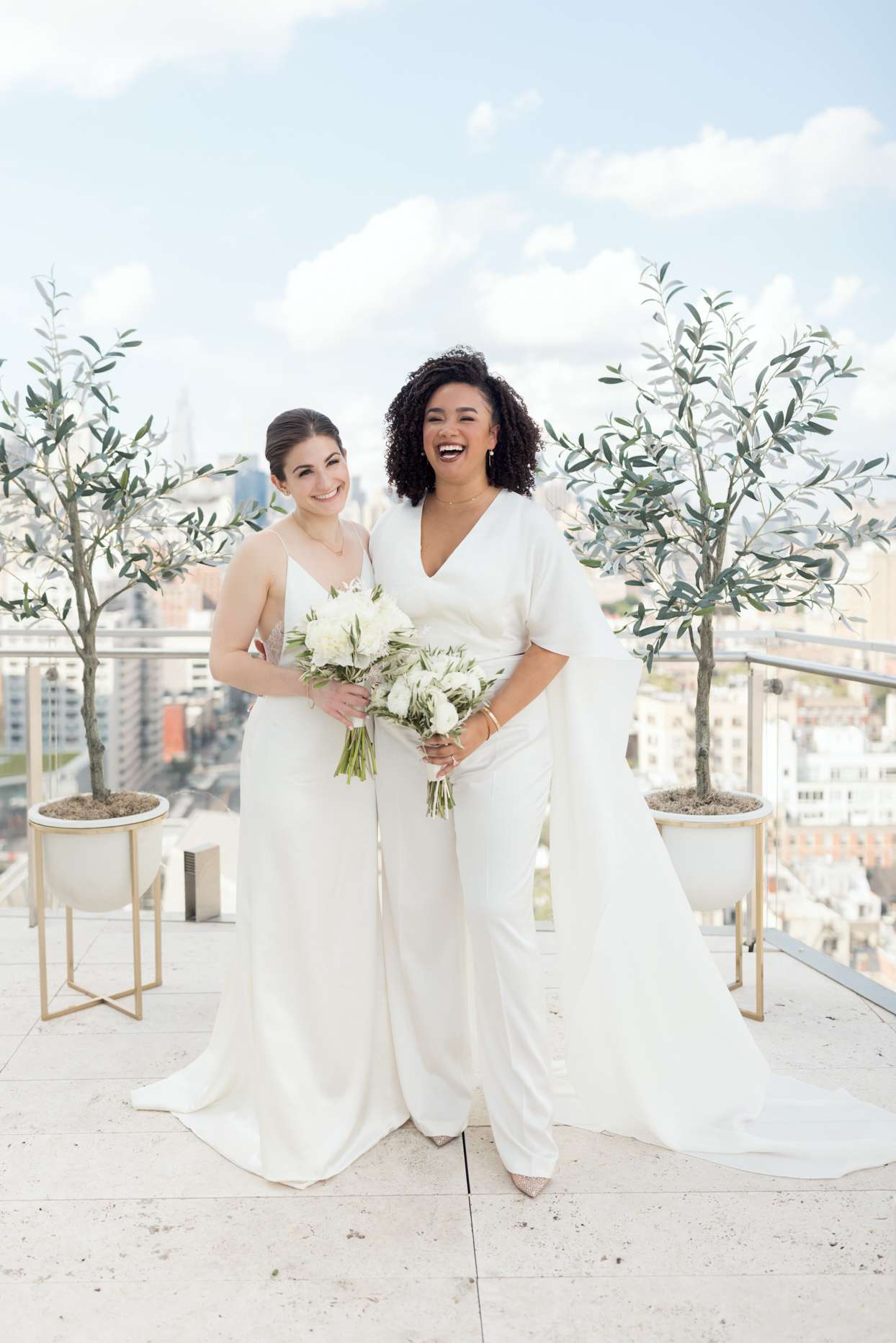 brides holding bouquets with white flowers