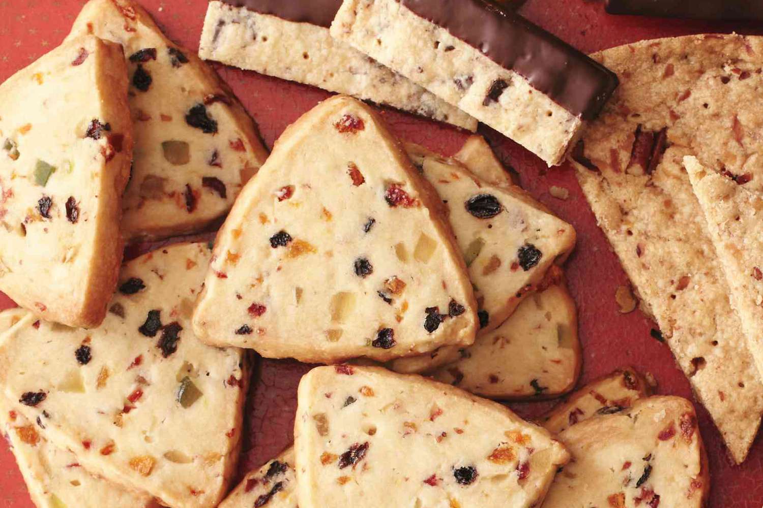 Assorted fruitcake and shortbread cookies arranged on a surface