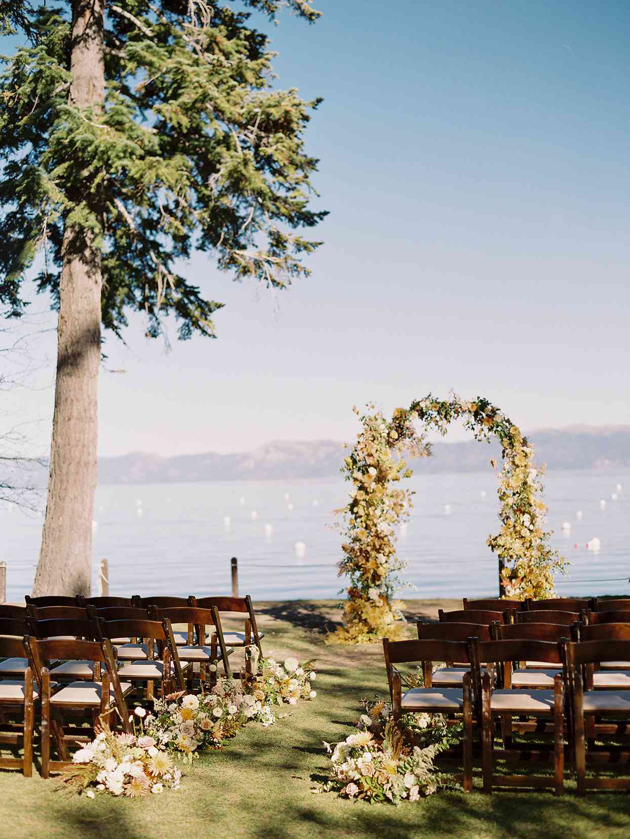 alexandra david wedding ceremony location floral arch overlooking lake