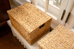 Woven storage baskets on a window sill one open with contents not visible