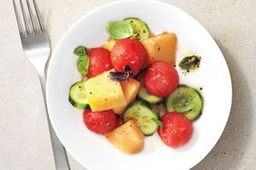 watermelon, cantaloupe, and cucumber salad on a white plate