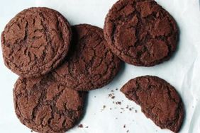 Several chocolate cookies with one partially eaten