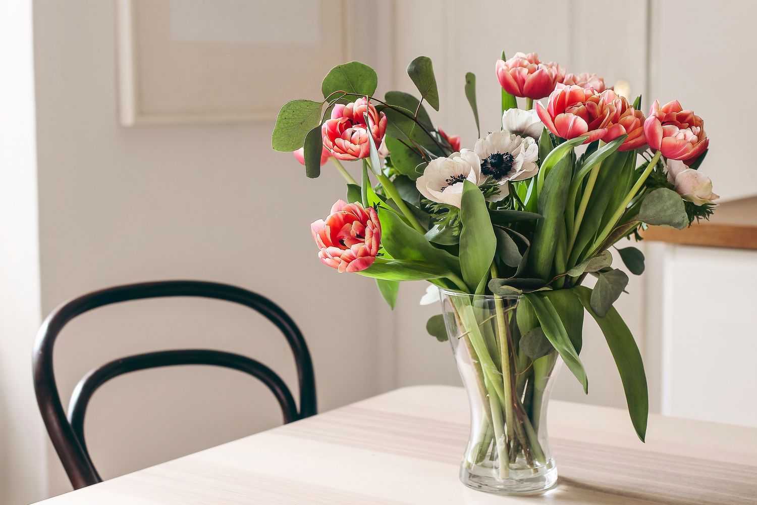 spring flower bouquet in shade on dining room table