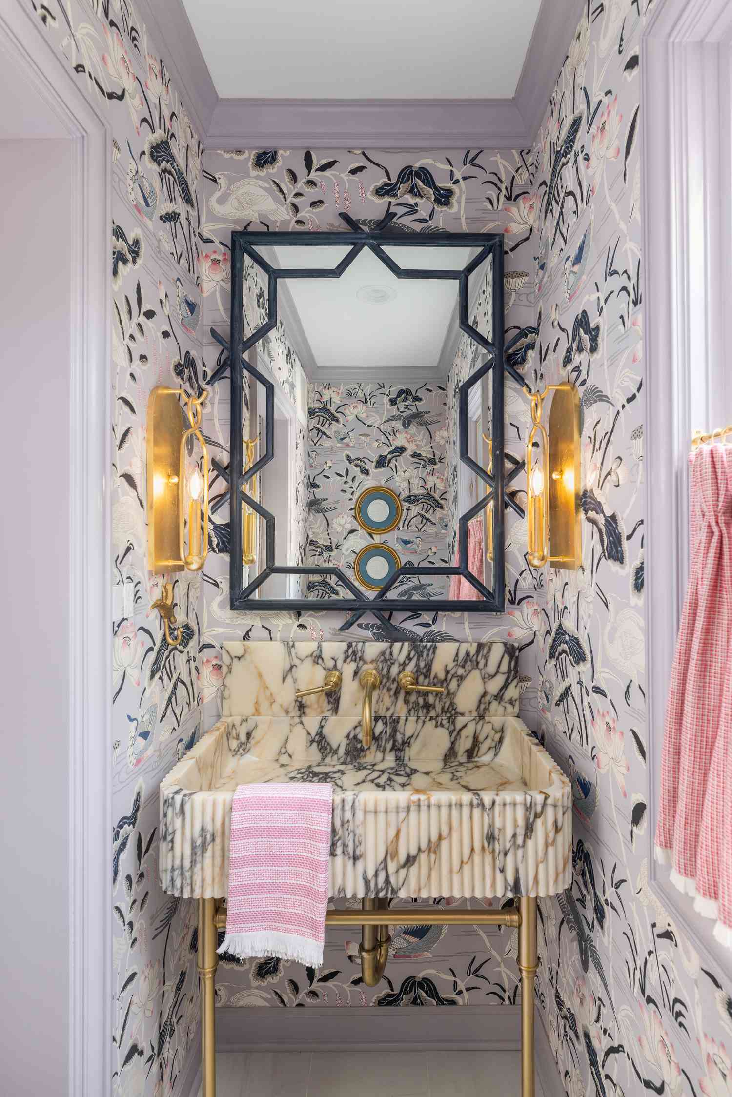 a lilac powder bathroom with a fluted viola marble sink basin