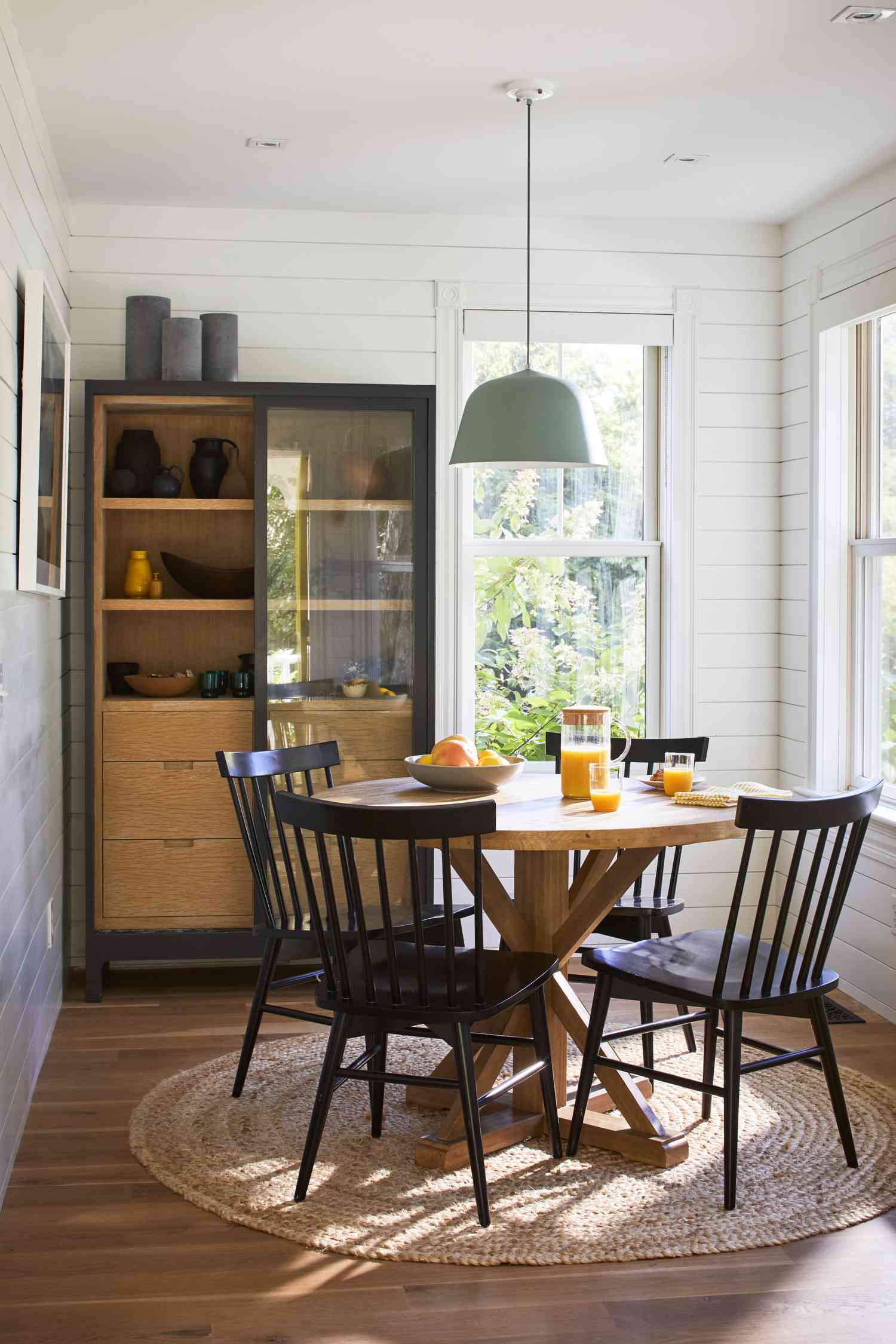 A round area rug beneath a table in a small dining room