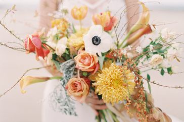 orange bouquet with calla lilies dahlias and roses