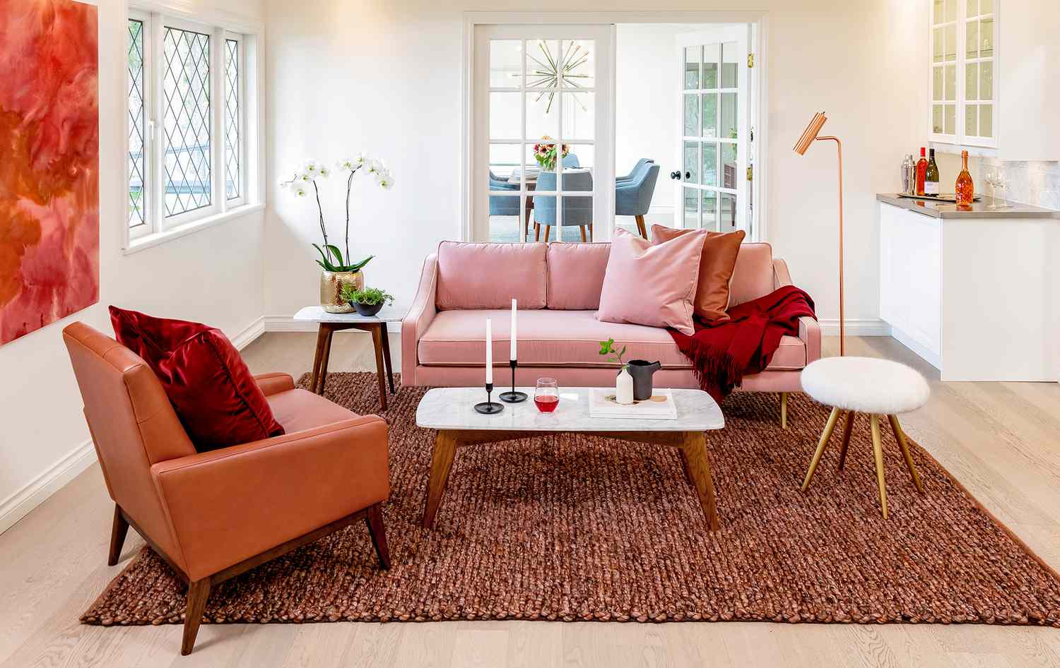 Living room with pink couch and textured rug