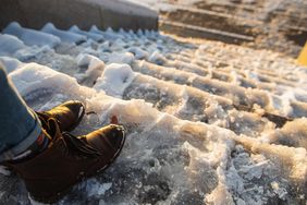 Persons boots on icy outdoor steps winter scene with snow and sunlight