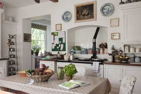 A cozy kitchen interior with a dining table various kitchen items and a window bringing in natural light