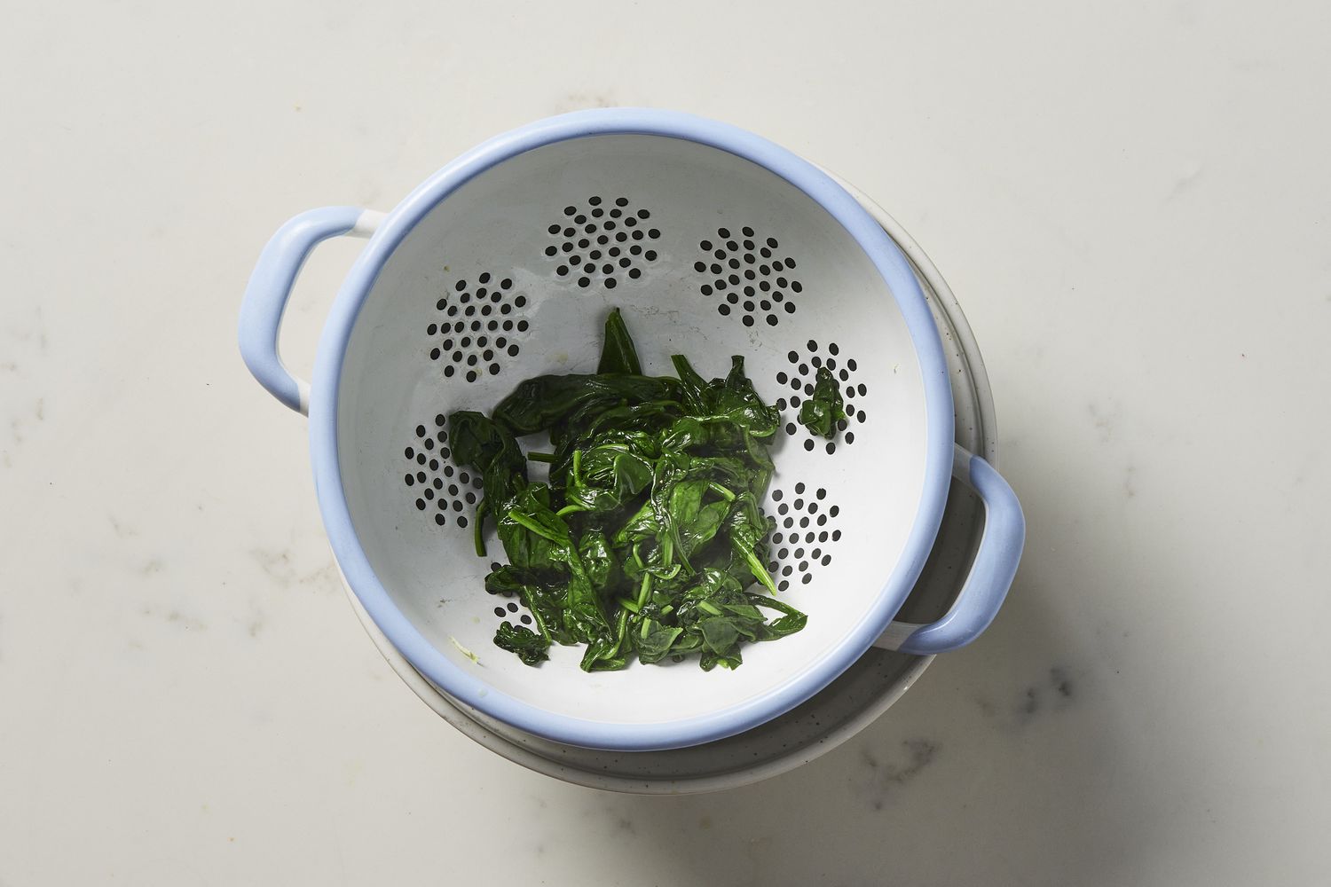 Spinach draining in collander