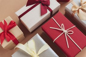 Gift boxes on craft paper background. Birthday, Christmas or Valentines day concept. Top view.