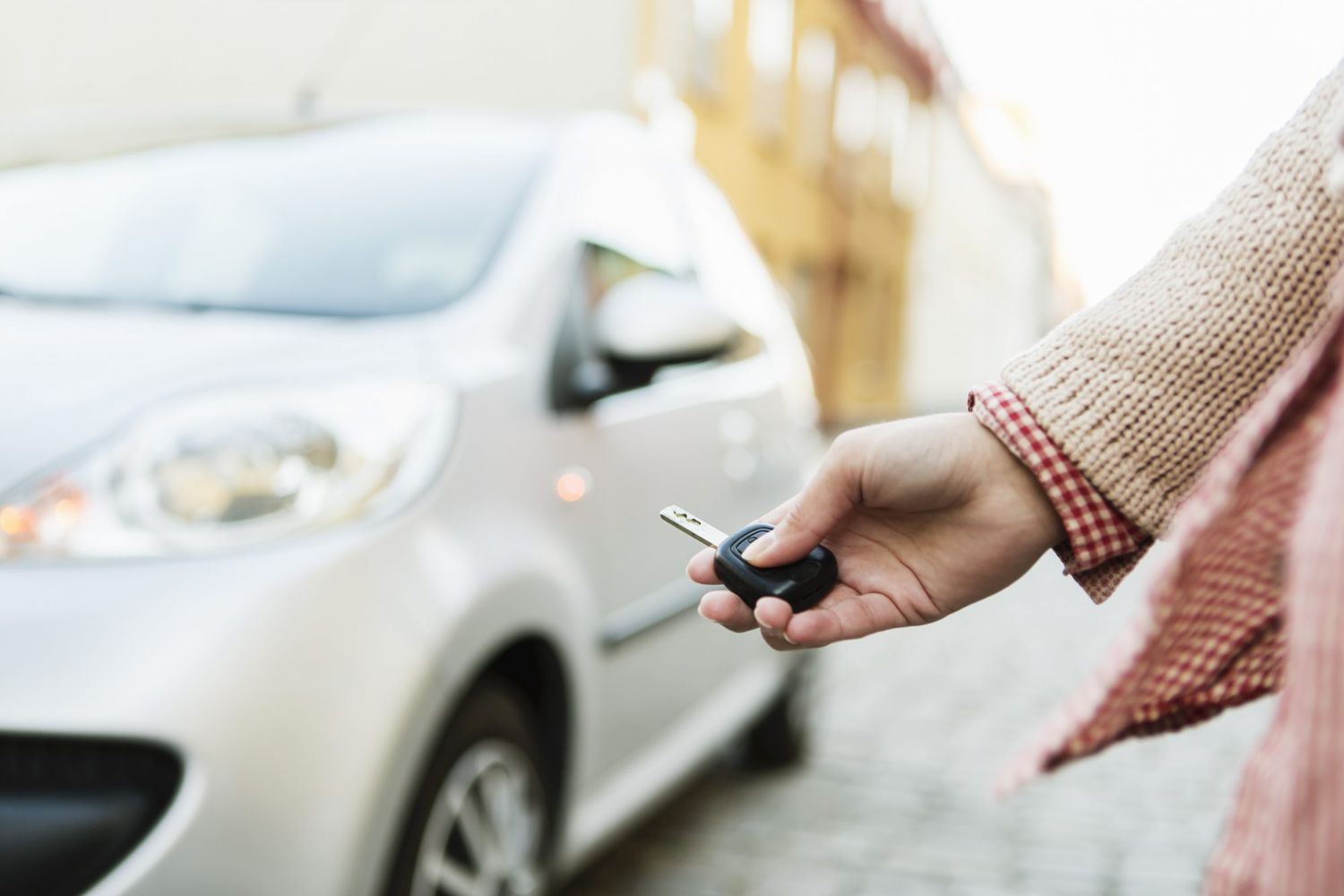 woman walking away from a parked car