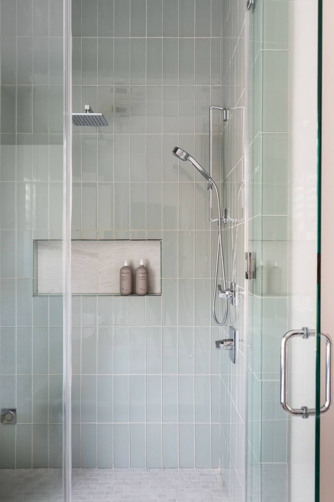 a shower with neutral tiles
