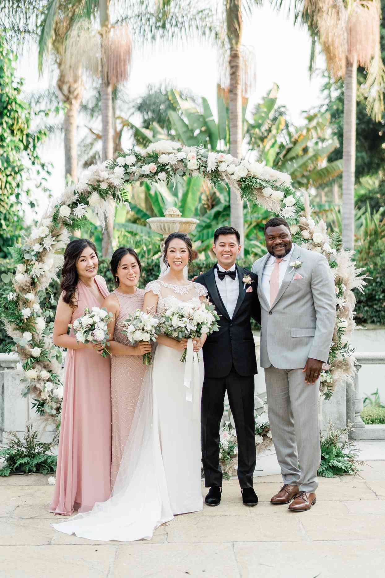 Bridal party posing in greenery