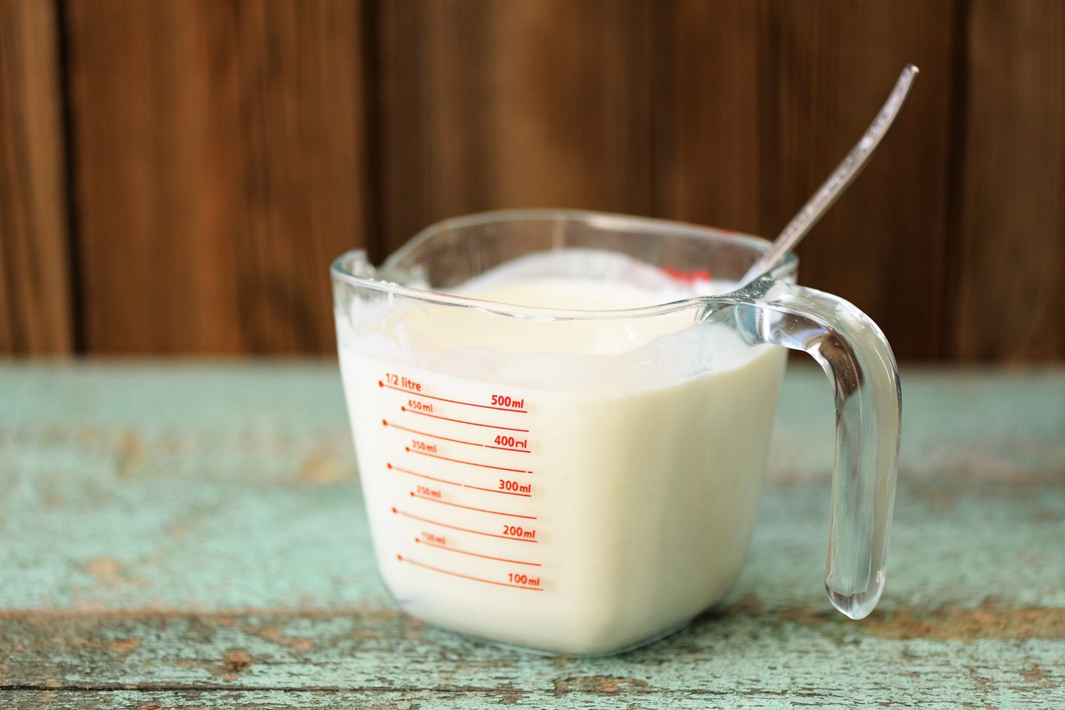 cream in measuring cup on table