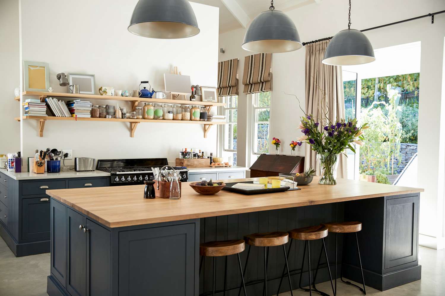 beautiful kitchen with black island and wood countertops