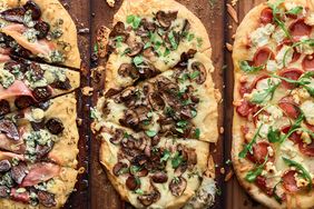 3 different pizzas on grilling planks