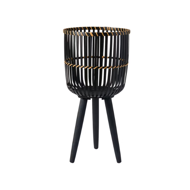 A standing decorative basket with slatted design and three legs