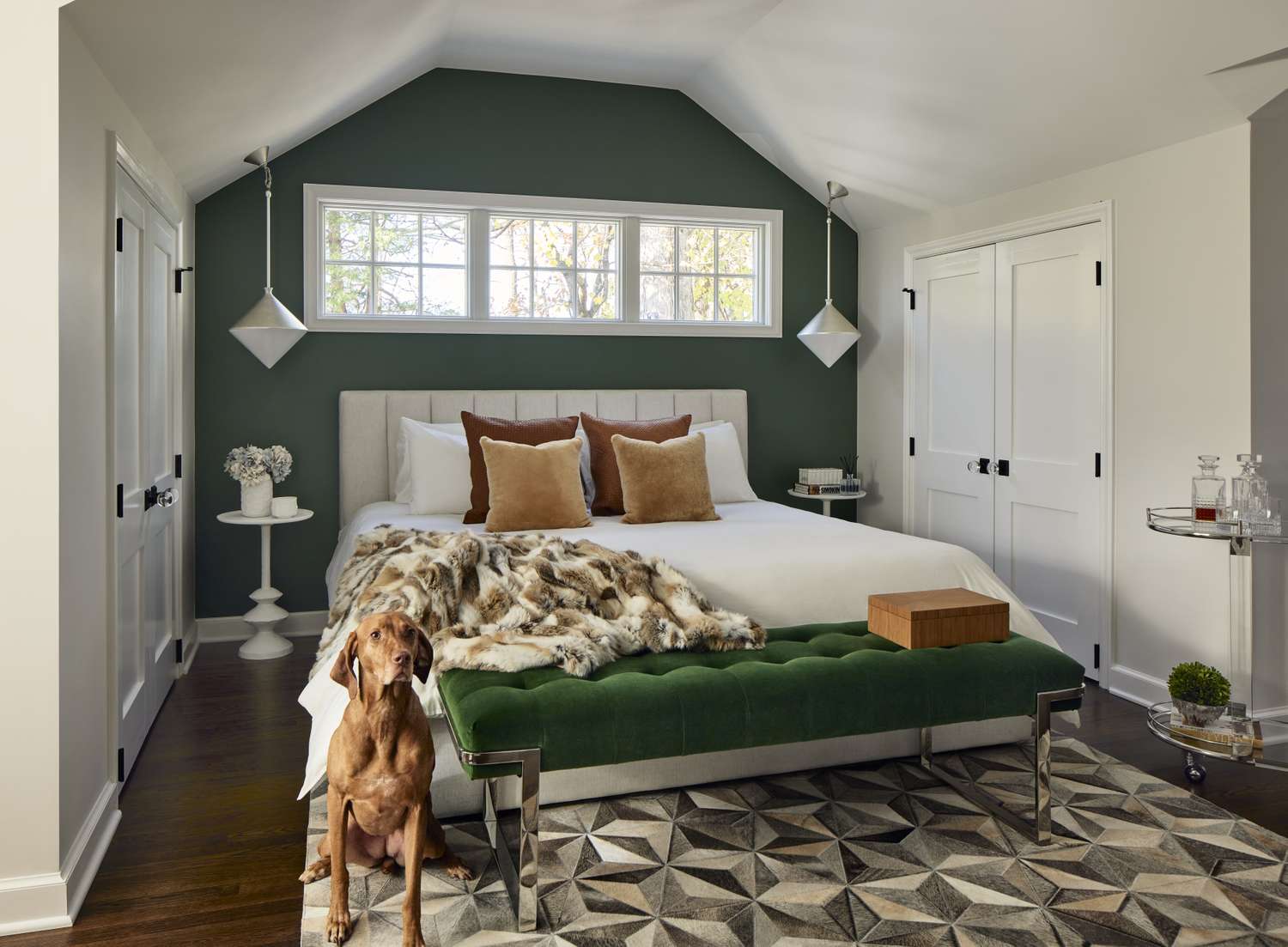 Green bedroom with a plush throw