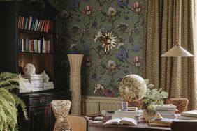 A room with floral wallpaper and animal print upholstery