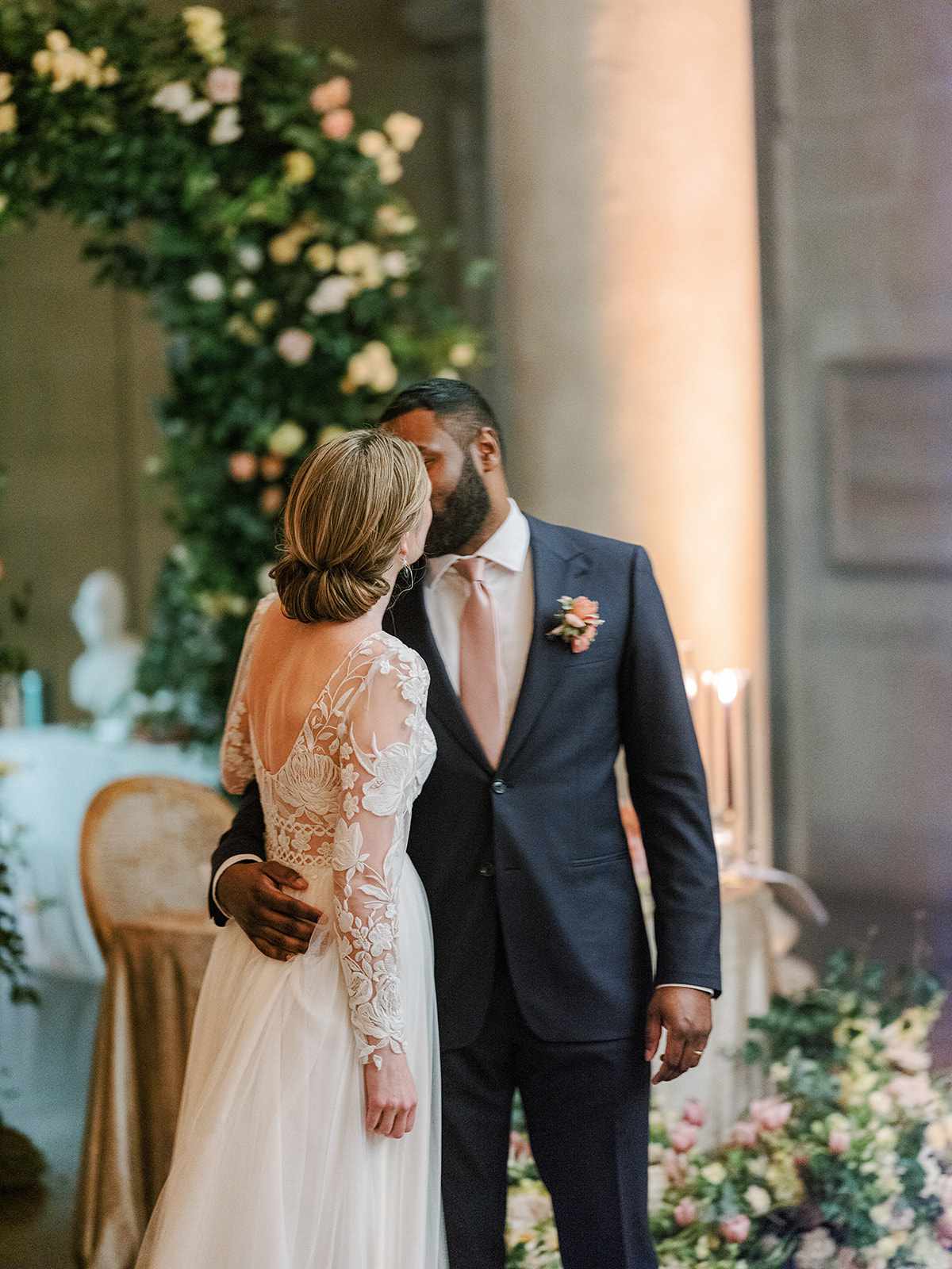 bride and groom kissing at wedding reception