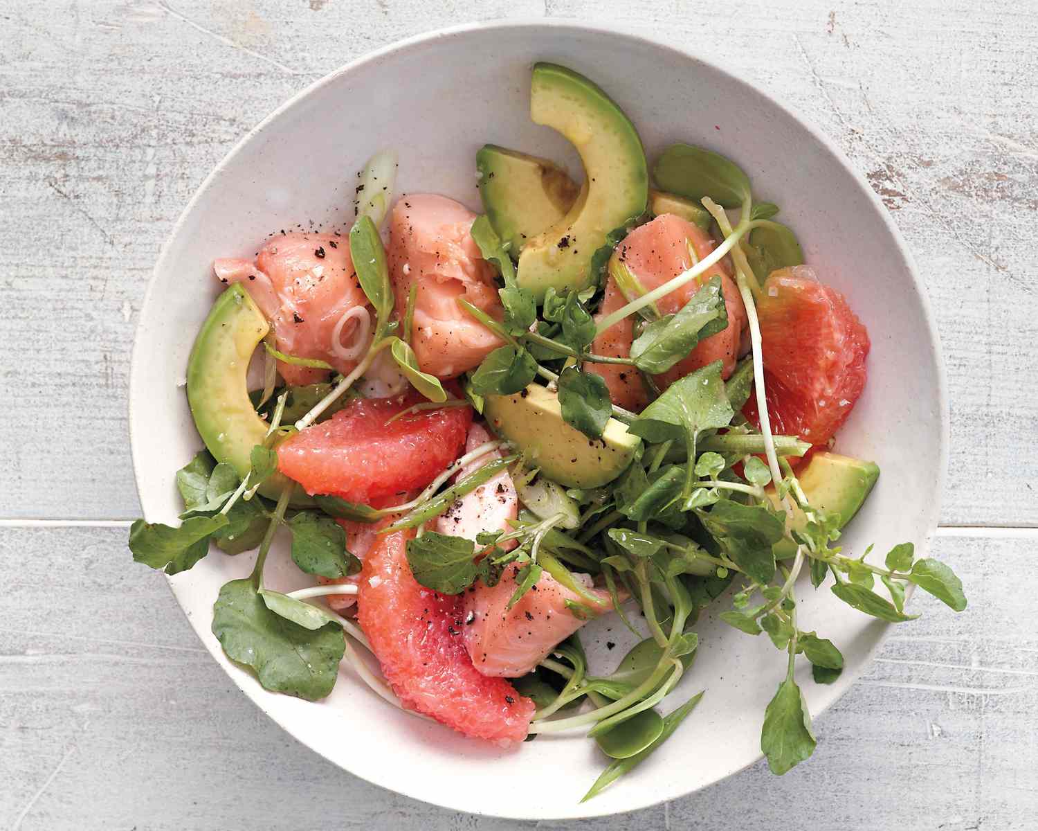 grapefruit and salmon salad on white background