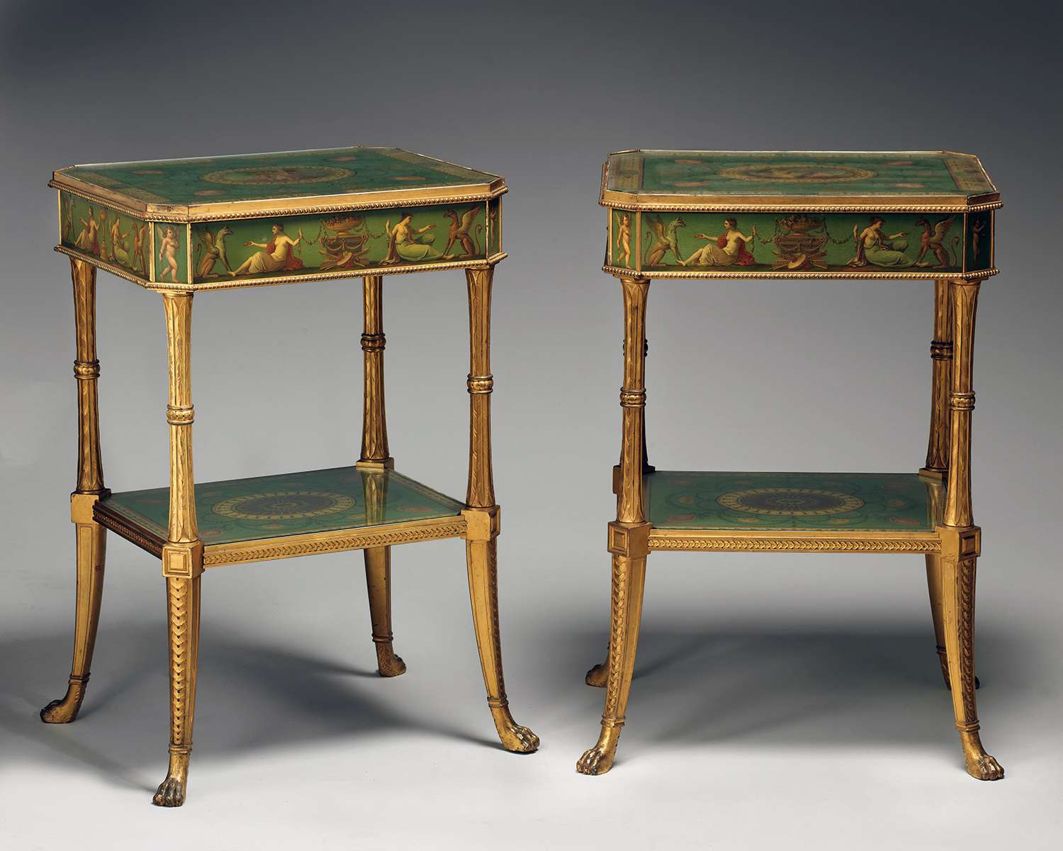 Two elaborately designed side tables with decorative motifs and intricate details