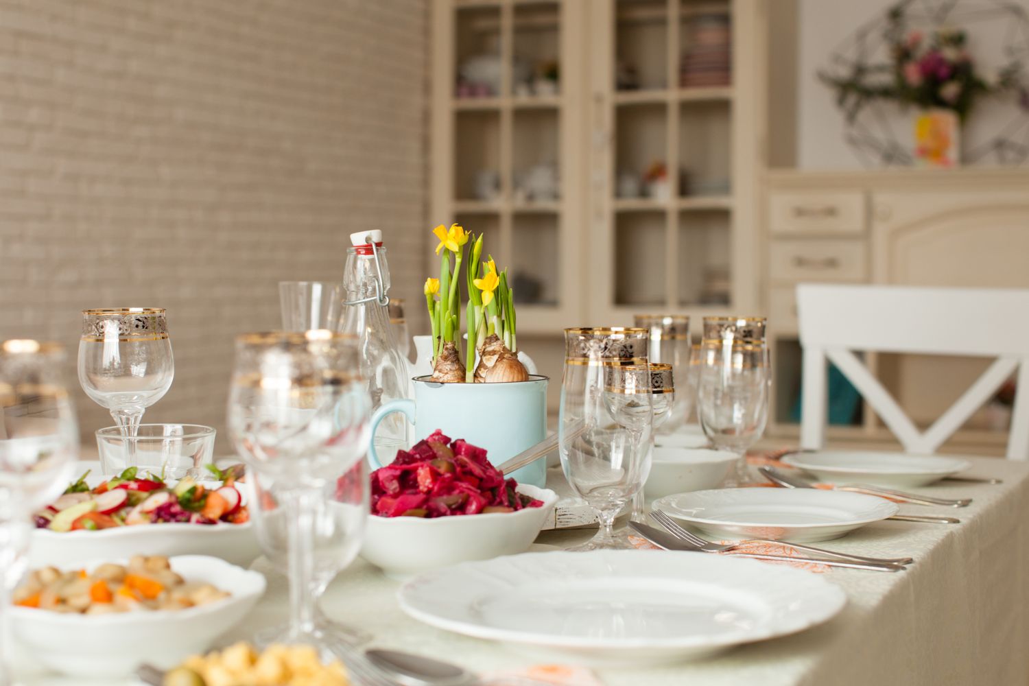 Table set with glassware plates and bowls of food