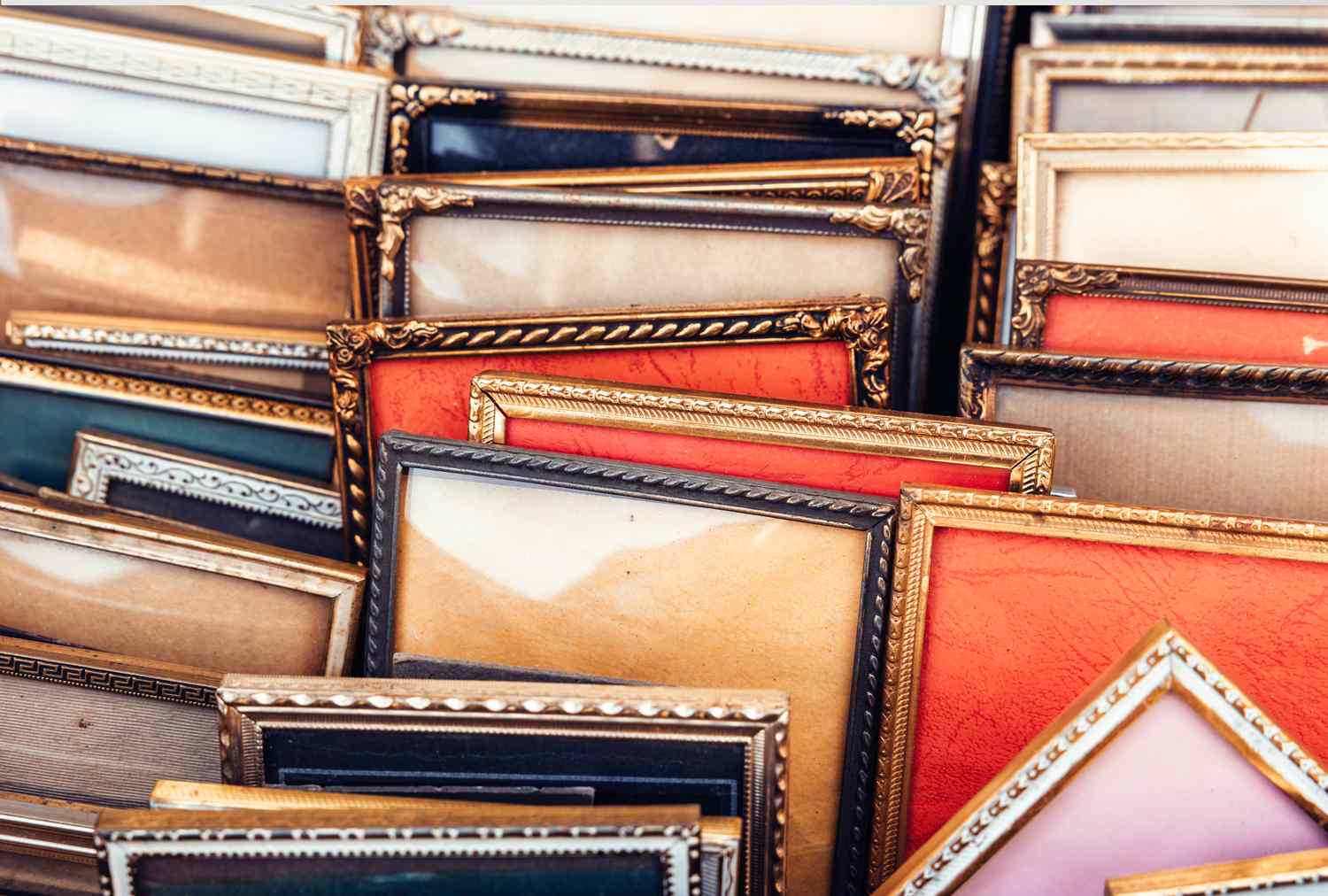 A variety of ornate vintage frames stacked closely together
