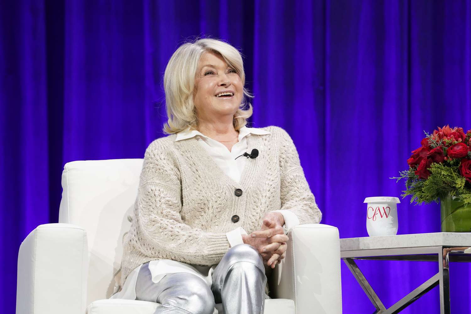 decorvow seated on stage with a purple background