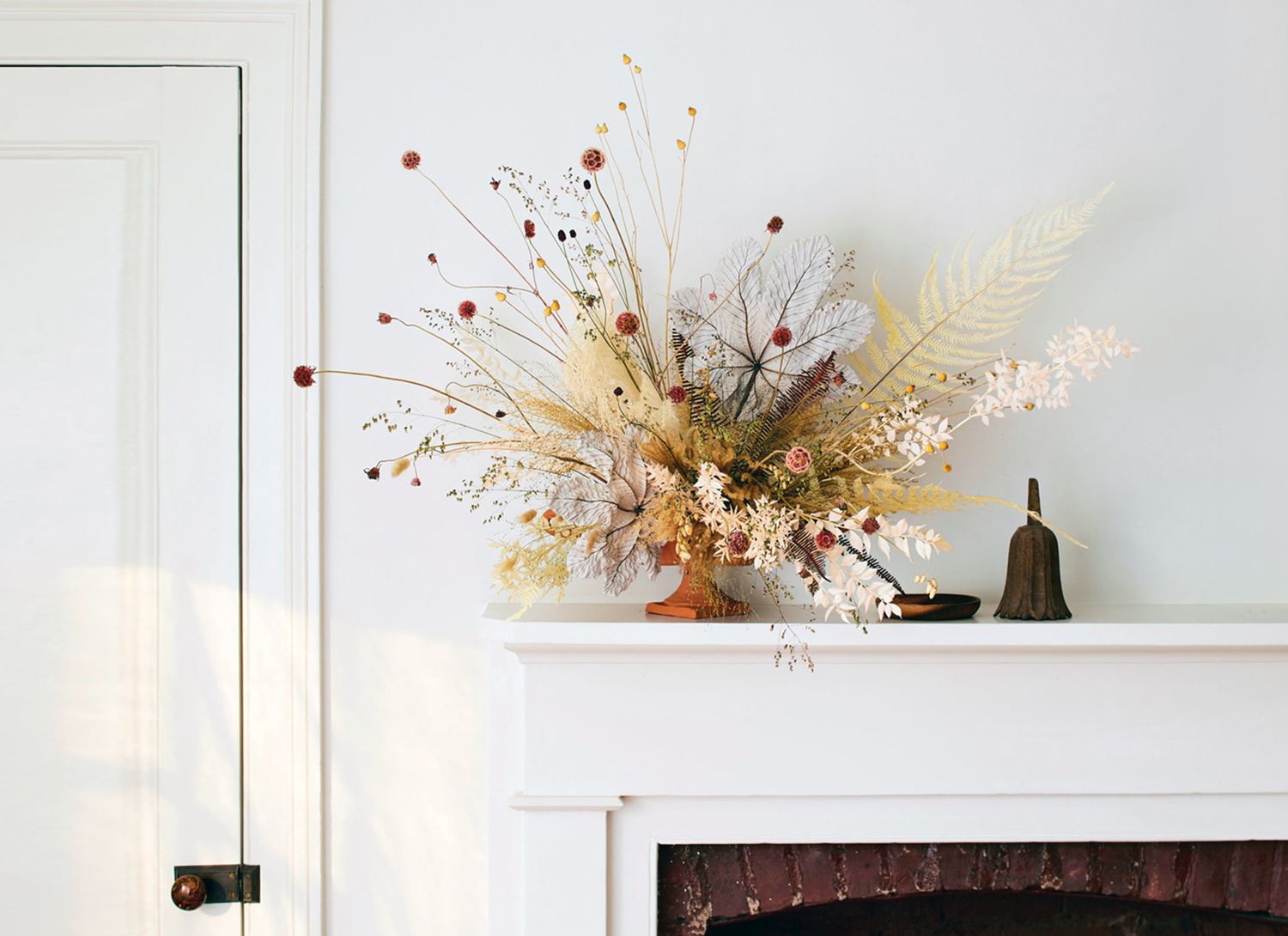 bouquet of dried flowers on a fireplace mantle