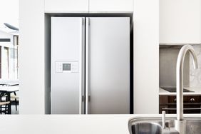 A modern kitchen with a stainless steel refrigerator and sink