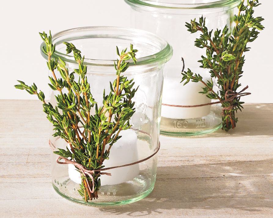 votice candle in jar with rosemary sprigs