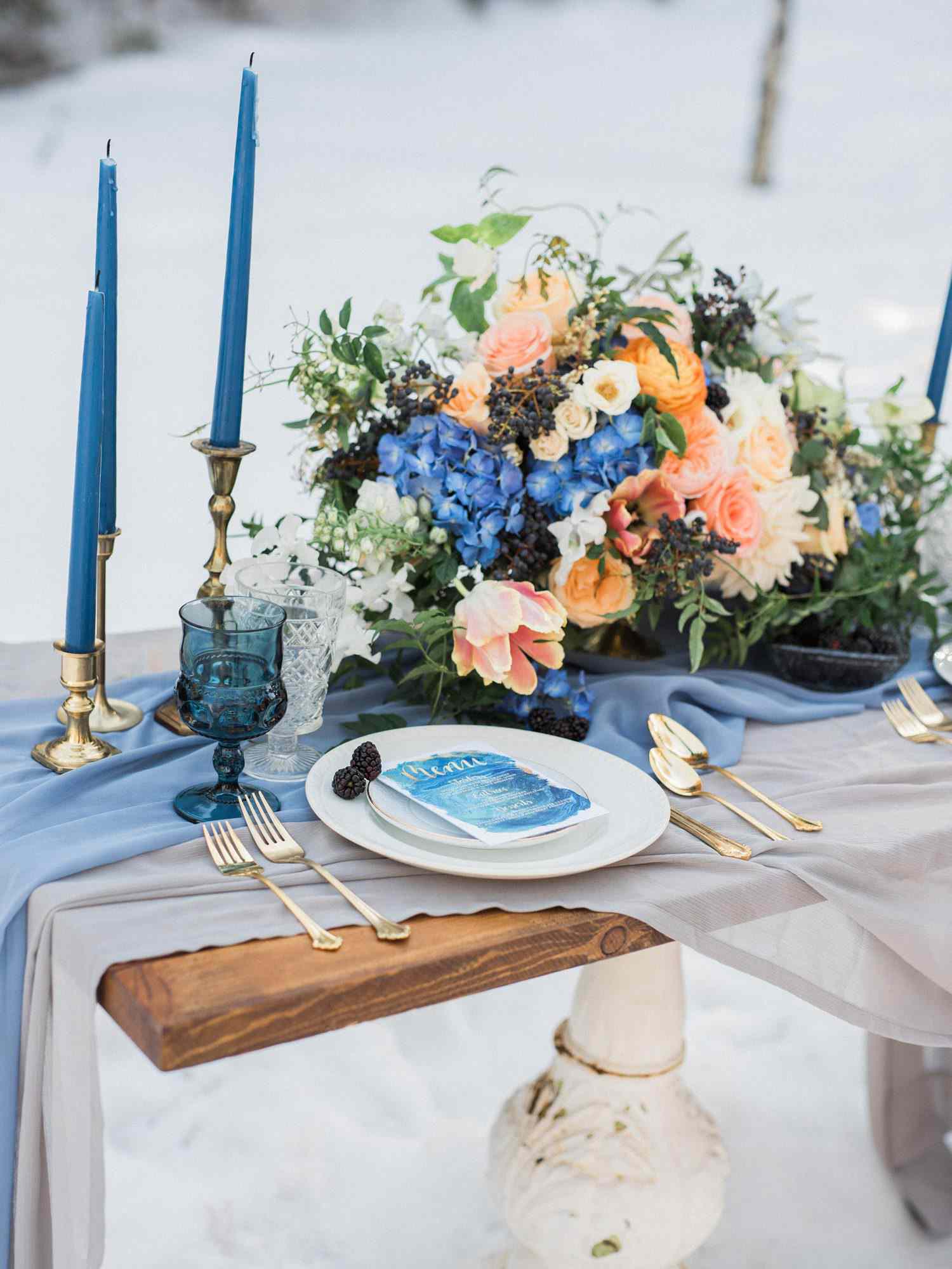 centerpiece with blue flowers and orange garden roses