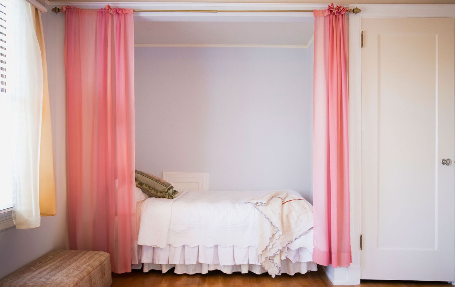 Bed in a nook with curtains