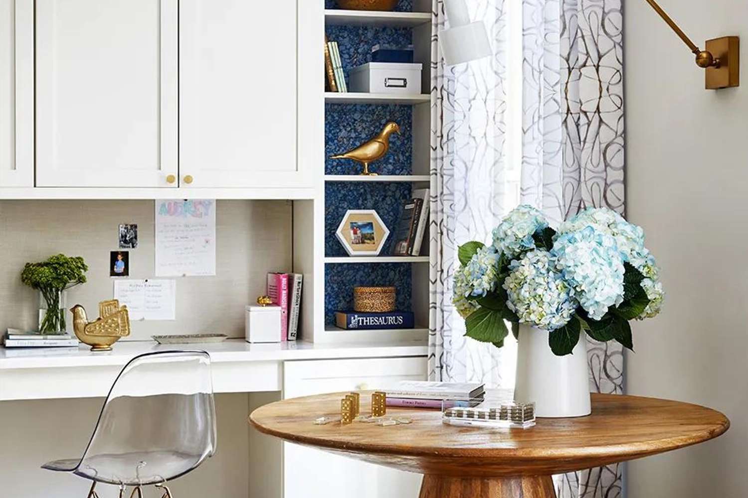 desk and white shelving with blue wallpaper accent