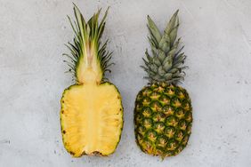 pineapple halves, one showing interior and one showing exterior