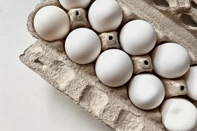 white eggs in grey cardboard carton