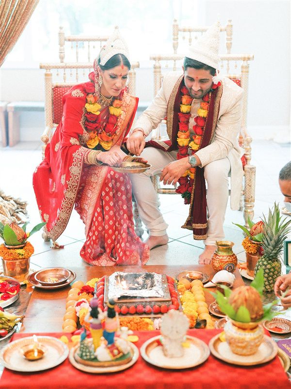 bride and groom performing traditional ritual during hindu ceremony