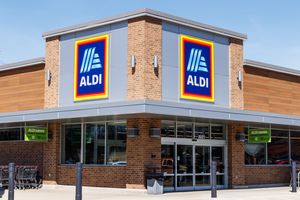 Aldi supermarket storefront brick building with Aldi logo prominently displayed