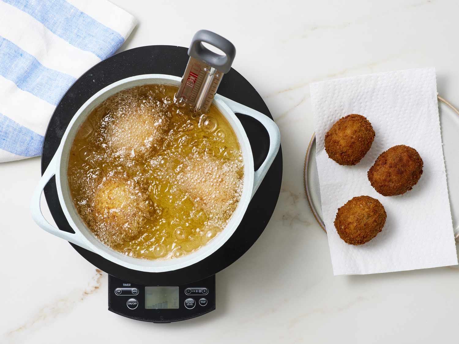 Scotch eggs being fried