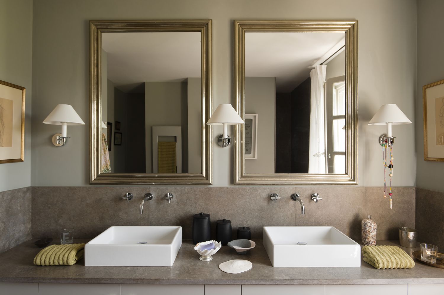 A bathroom with dual sinks and mirrors above each sink featuring minimalist decor