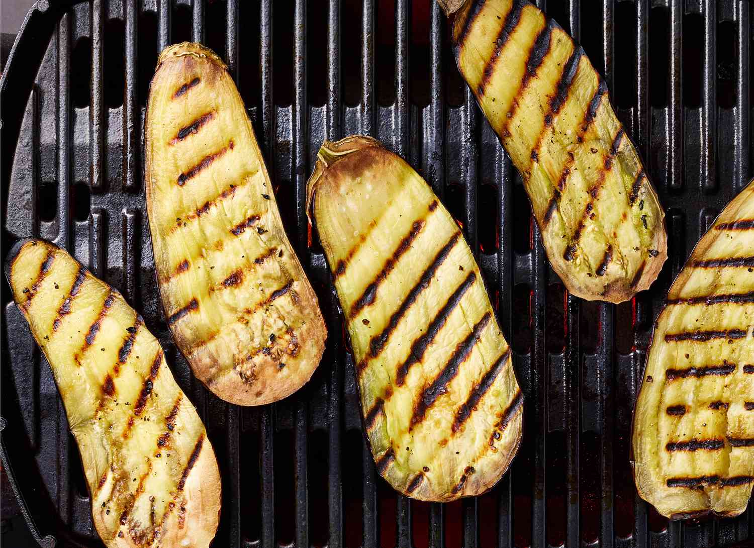 overhead view of grilled eggplant on grill