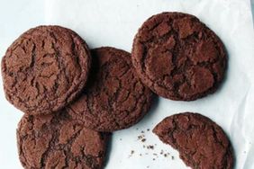 Several chocolate cookies with one partially eaten