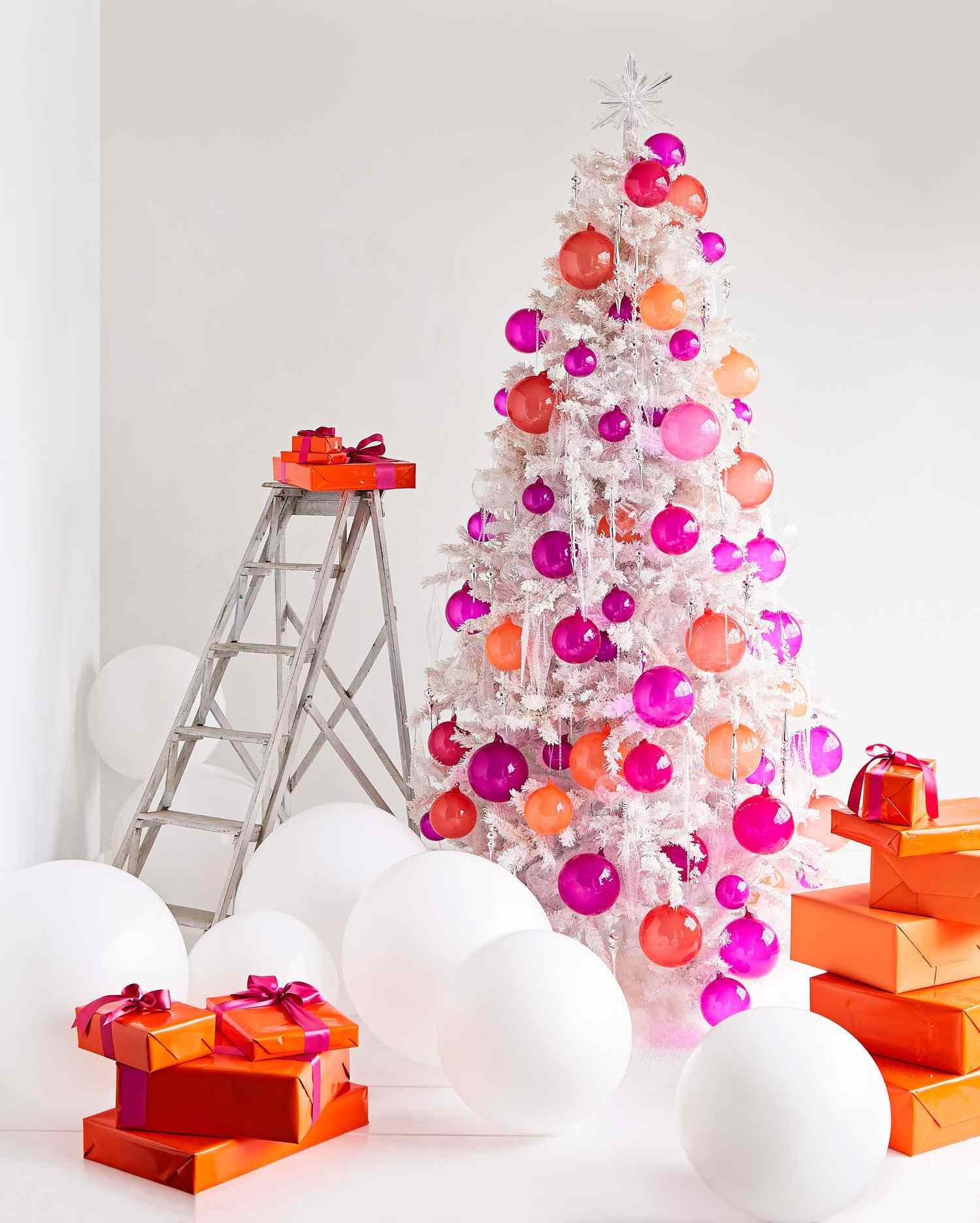 white Christmas tree of pink and orange ornaments