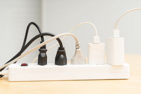 A power strip with multiple cables and plugs connected