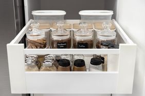 Organized spice drawer containing labeled jars and containers